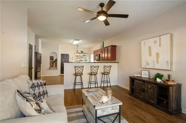 a living room with furniture and kitchen view