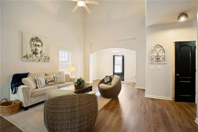 a living room with furniture a rug and a wall painting