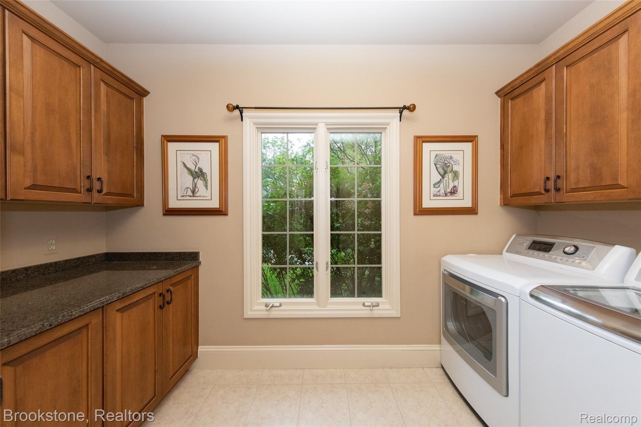 7868 Holcomb Road Clarkston, MI 48348 - Photo 33 of 60 Super Spacious Entry Level Laundry Room boasts extensive storage