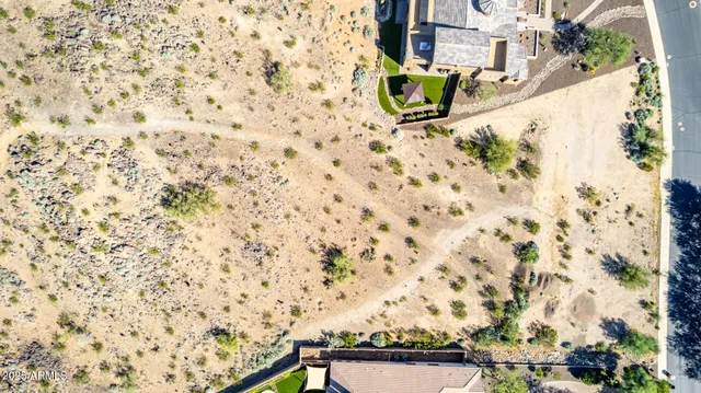 an aerial view of residential houses with yard and trees in the back