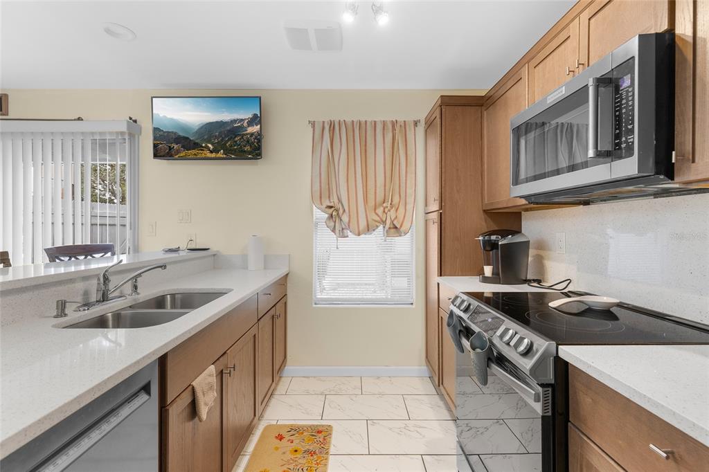 2004 Ludlow Lane, Unit 2803 Orlando, FL 32839 - Photo 12 of 31 a kitchen that has a sink and a stove
