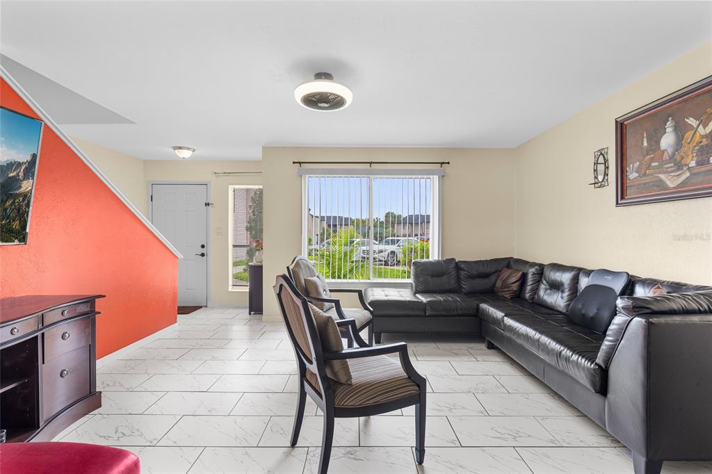 2004 Ludlow Lane, Unit 2803 Orlando, FL 32839 - Photo 4 of 31 a living room with furniture and a large window