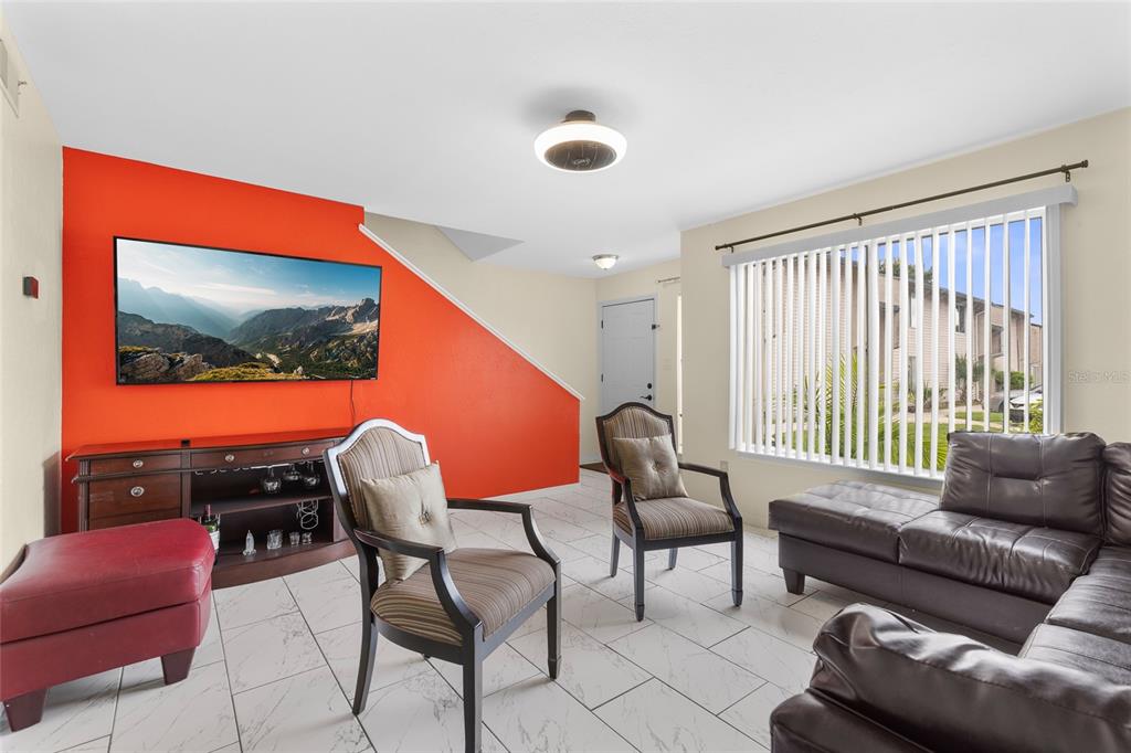 2004 Ludlow Lane, Unit 2803 Orlando, FL 32839 - Photo 5 of 31 a living room with furniture and a flat screen tv