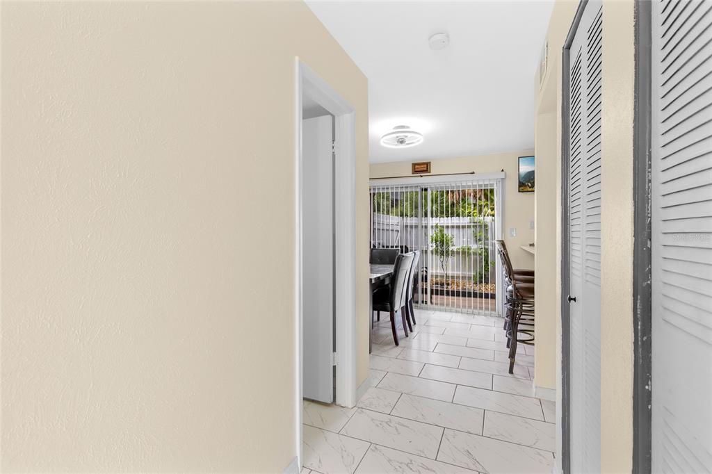 2004 Ludlow Lane, Unit 2803 Orlando, FL 32839 - Photo 6 of 31 a view of a hallway with dining room and furniture