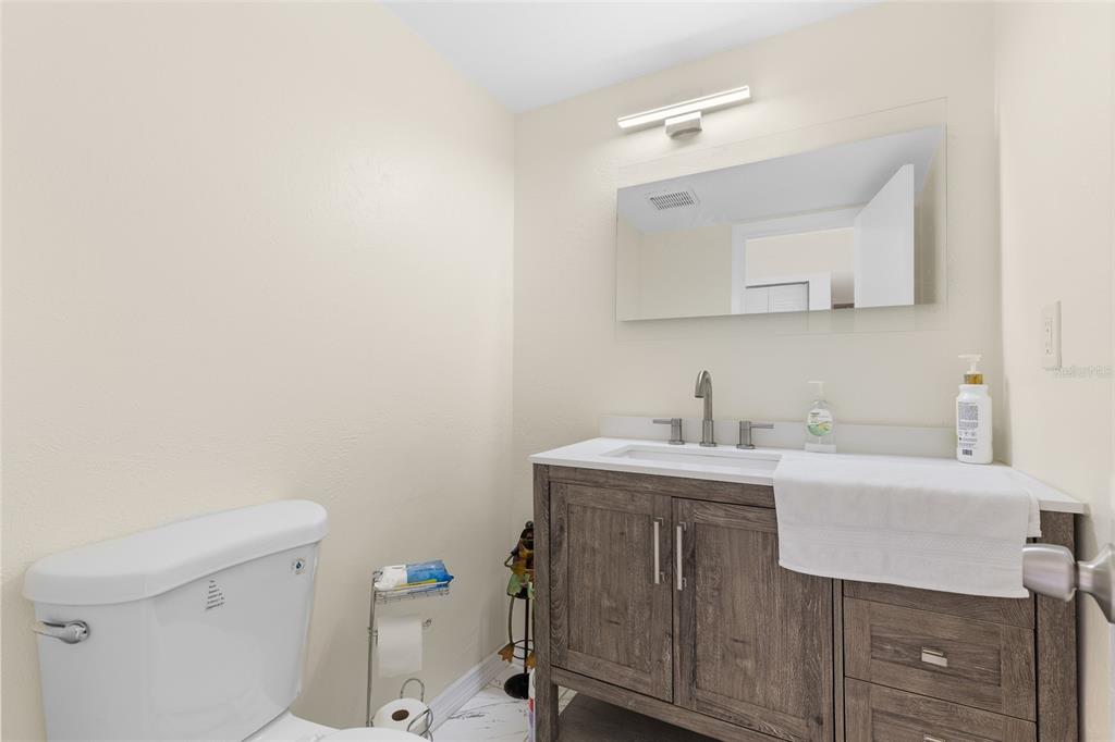 2004 Ludlow Lane, Unit 2803 Orlando, FL 32839 - Photo 7 of 31 a bathroom with a sink a toilet and mirror