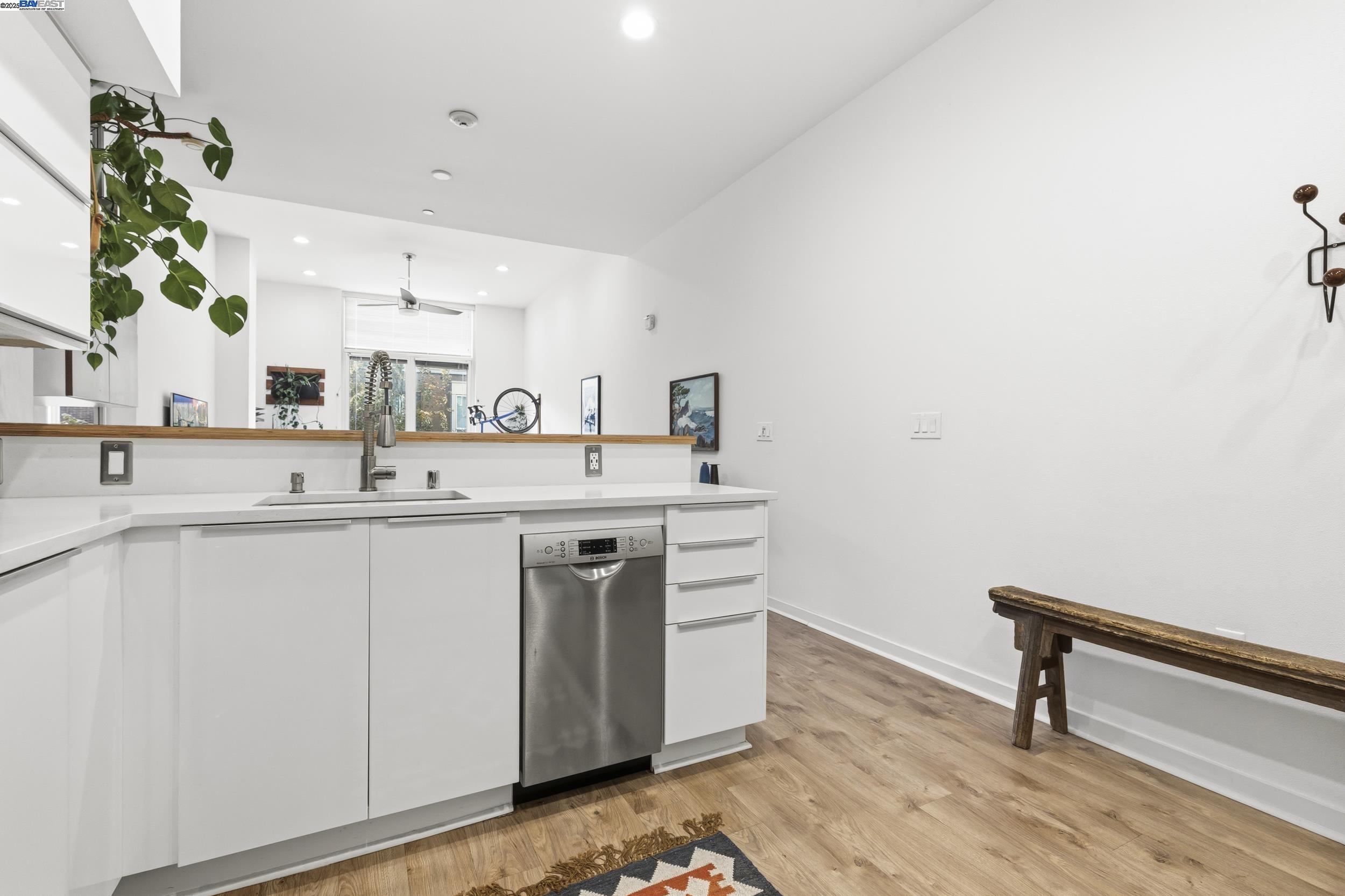 630 Thomas L Berkley Way, Unit 403 Oakland, CA 94612 - Photo 13 of 29 a kitchen with a sink cabinets and wooden floor