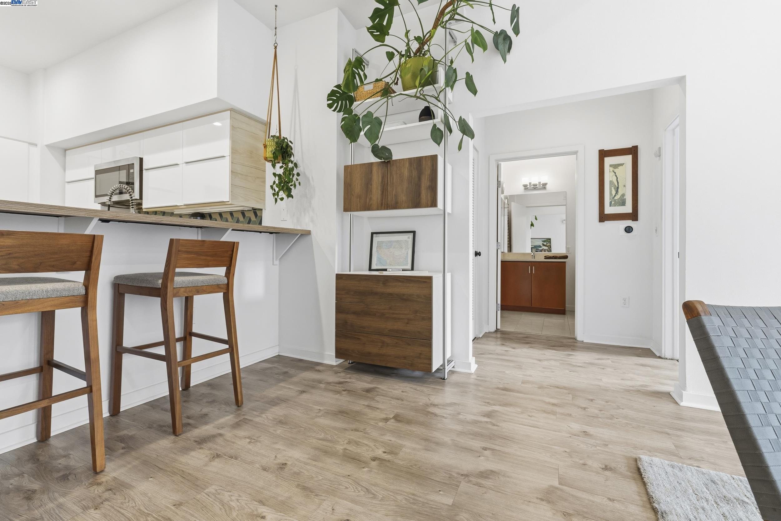 630 Thomas L Berkley Way, Unit 403 Oakland, CA 94612 - Photo 15 of 29 a room with furniture and a potted plant