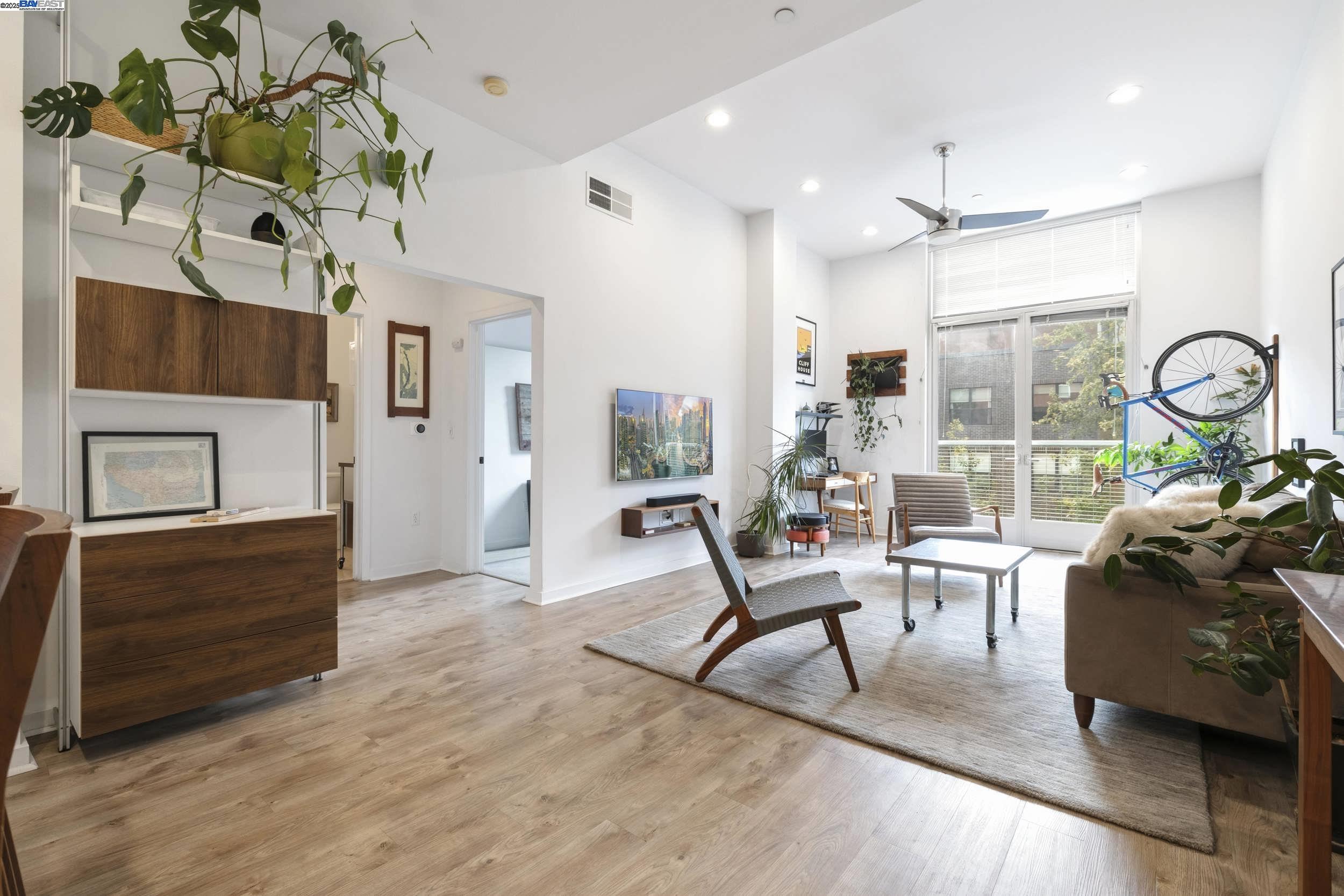 630 Thomas L Berkley Way, Unit 403 Oakland, CA 94612 - Photo 6 of 29 a living room with furniture and wooden floor
