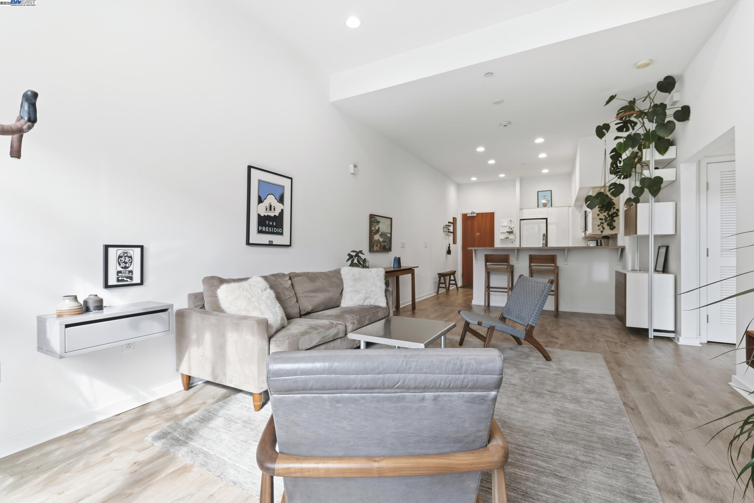 630 Thomas L Berkley Way, Unit 403 Oakland, CA 94612 - Photo 8 of 29 a living room with furniture and flowers