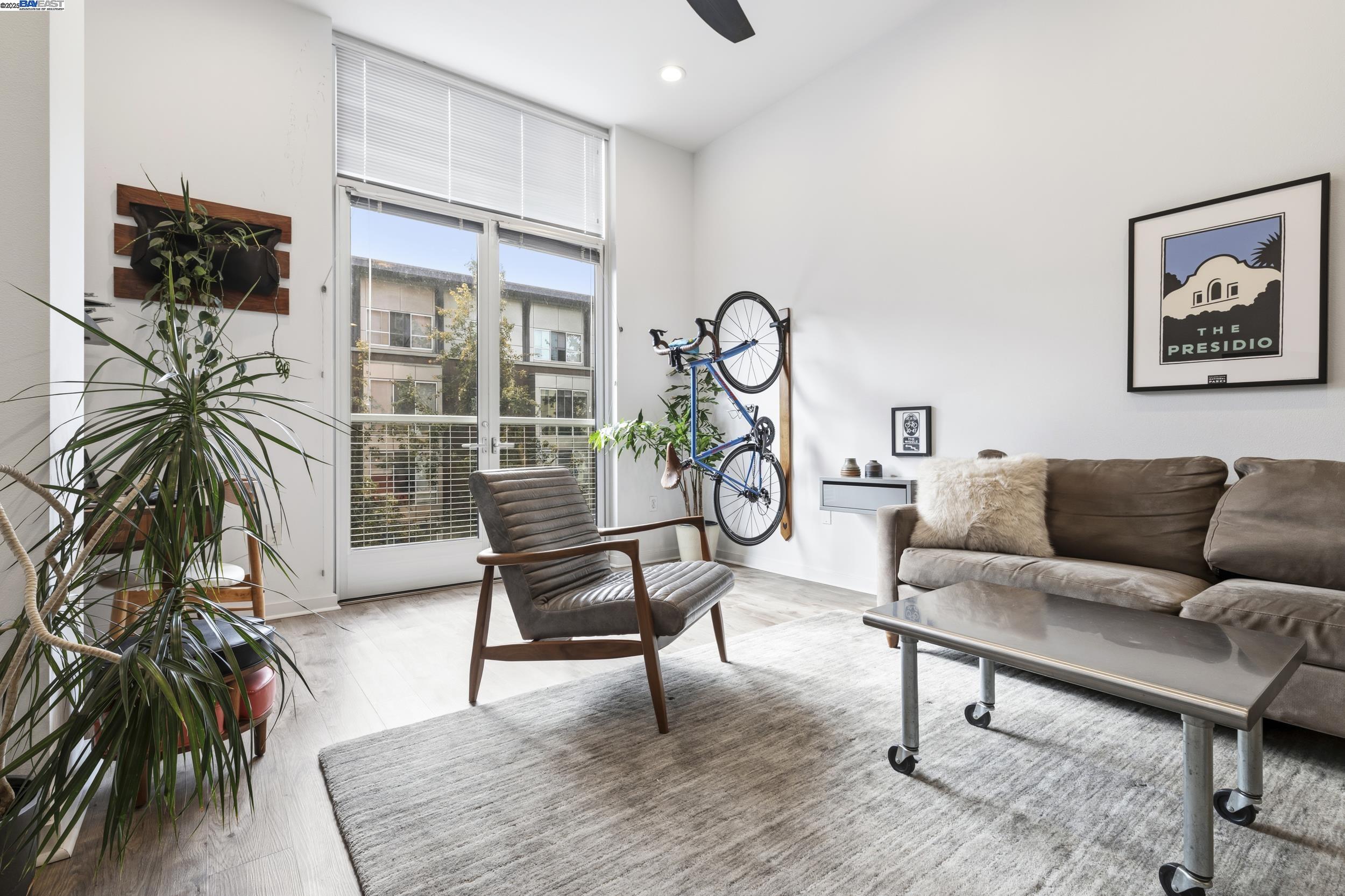 630 Thomas L Berkley Way, Unit 403 Oakland, CA 94612 - Photo 9 of 29 a living room with furniture a flat screen tv and a potted plant