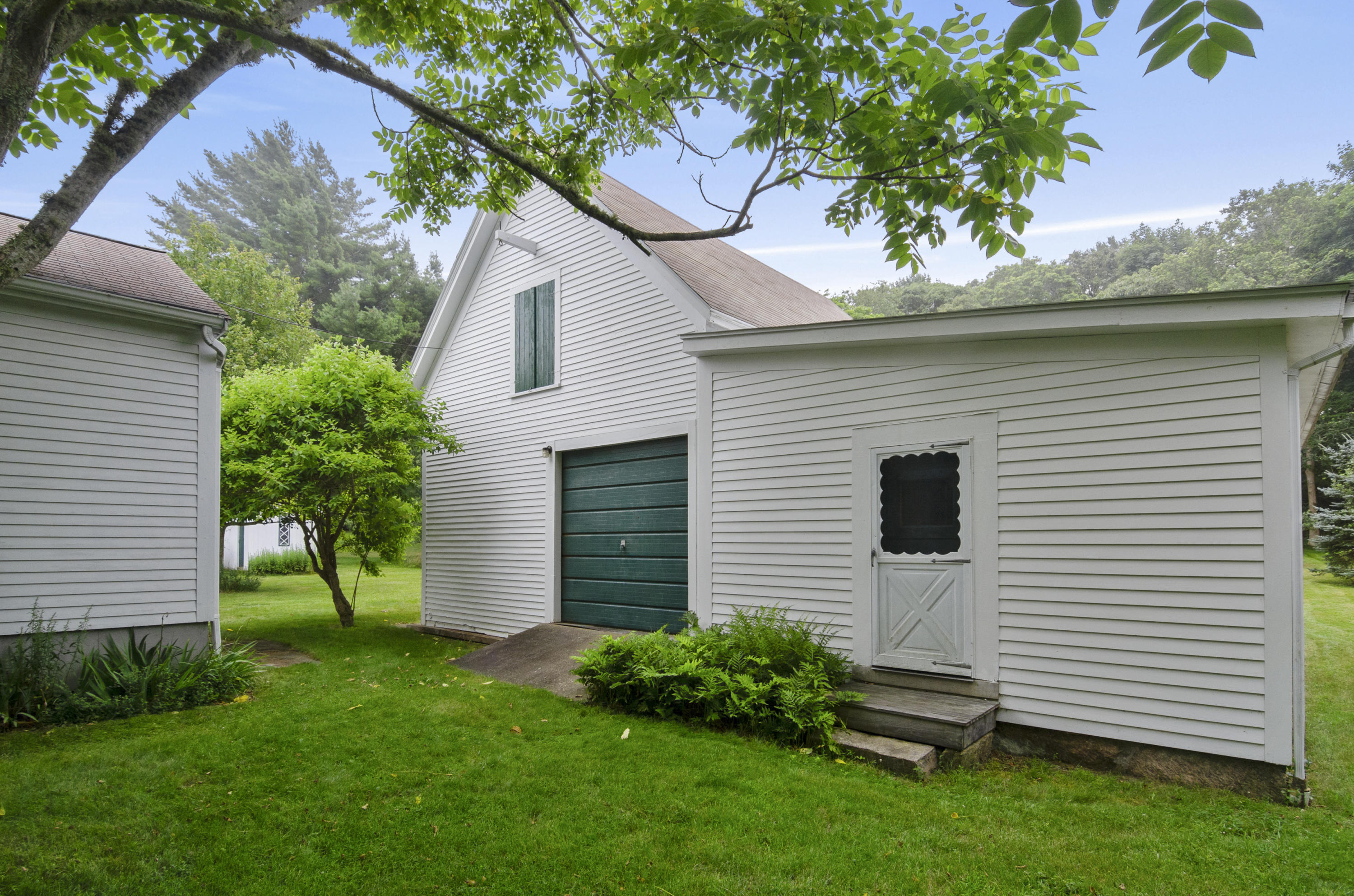 409 Barlows Landing Road Pocasset, MA 02559 - Photo 16 of 26 a front view of a house with a garden