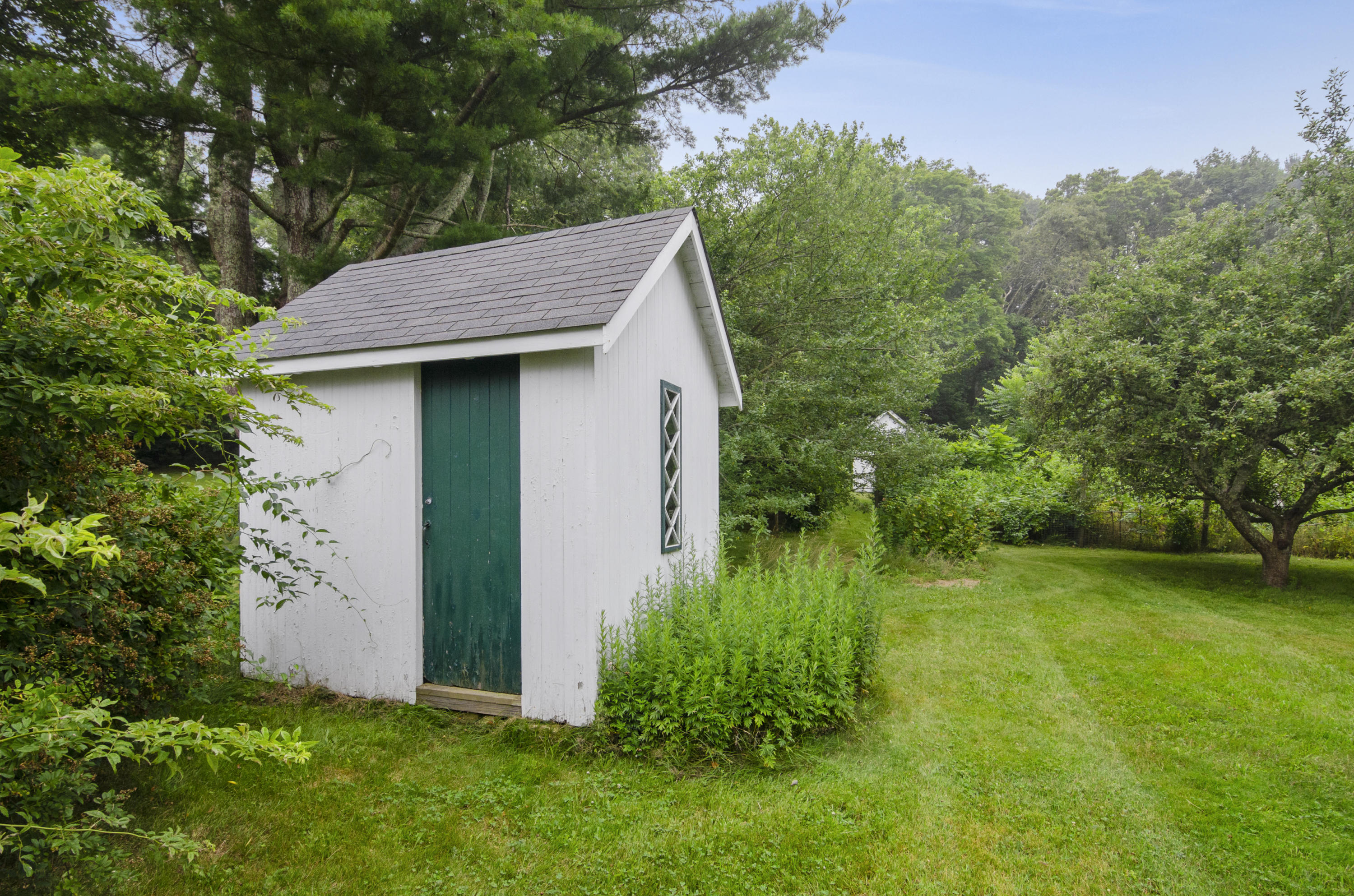 409 Barlows Landing Road Pocasset, MA 02559 - Photo 20 of 26 a backyard of a house with plants and large trees