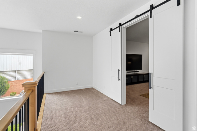 2278 Tawny Ridge Circle St. George, UT 84790 - Photo 36 of 61 Loft area featuring a neutral carpet, white walls, and recessed lighting.