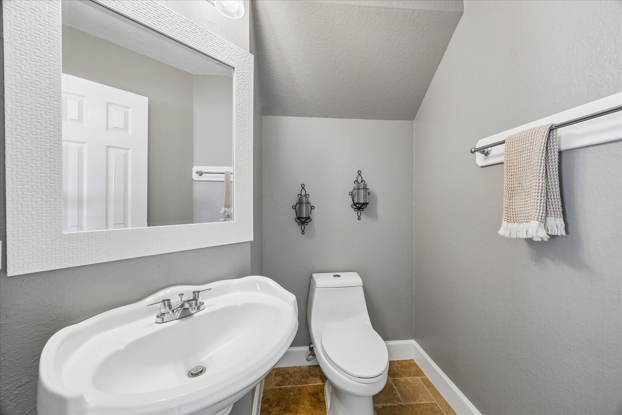 23234 Grand Rapids Lane Spring, TX 77373 - Photo 17 of 30 Charming half bath tucked under the stairs features a pedestal sink and elegant finishes — perfect for guests.