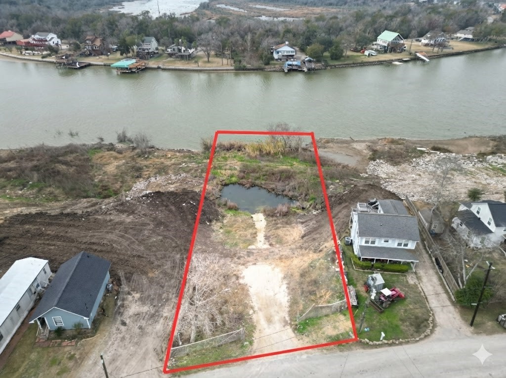 an aerial view of a houses with ocean view