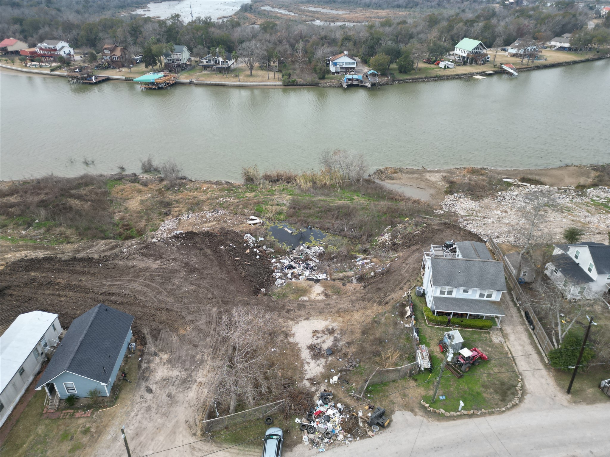 211 Riverside Street Highlands, TX 77562 - Photo 2 of 6 an aerial view of a house with a lake view