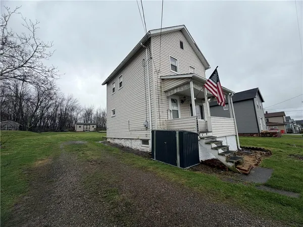 a front view of a house with a yard table and chairs