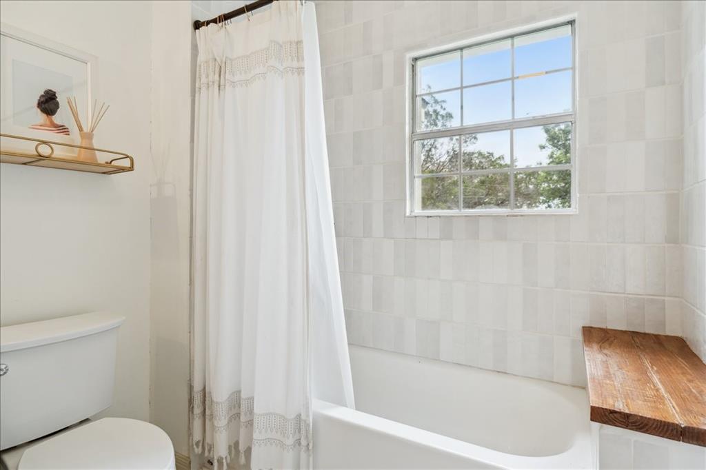 13347 Old China Spring Road China Spring, TX 76633 - Photo 22 of 38 a bathroom with a bathtub a window and a shower