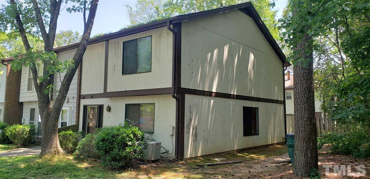 a view of a house with a large tree