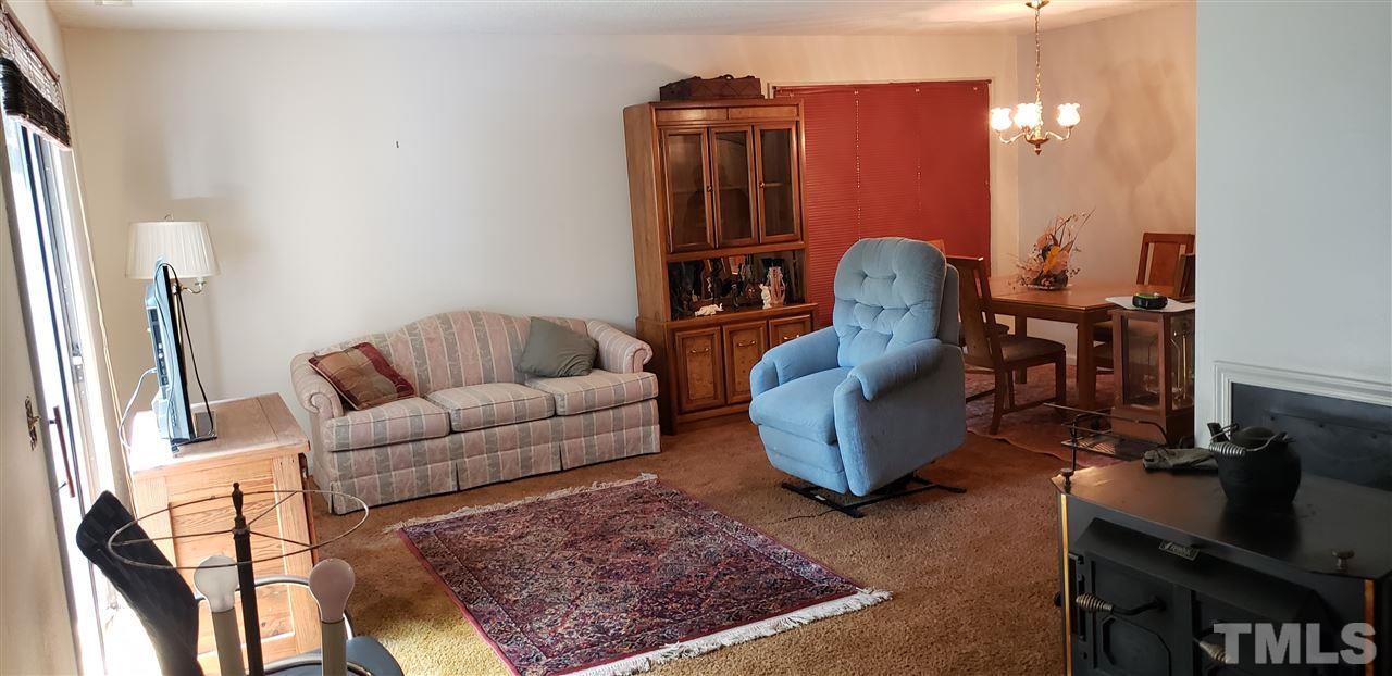 1227 Seaton Road, Unit 55 Durham, NC 27713 - Photo 3 of 6 a living room with furniture and a mirror