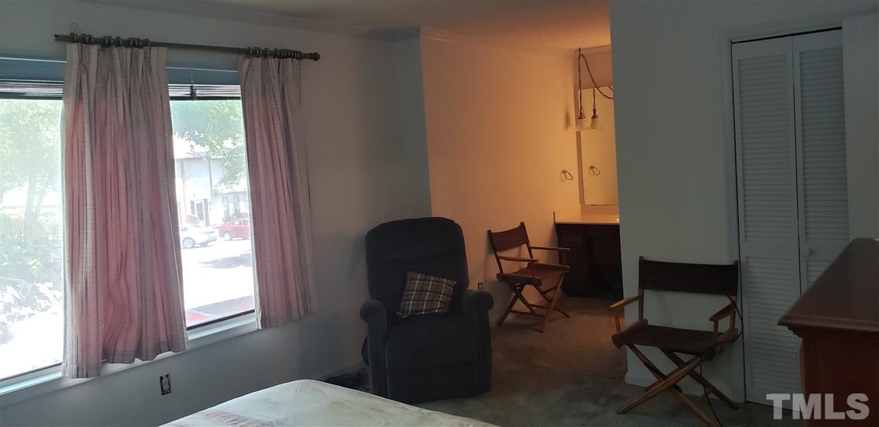 1227 Seaton Road, Unit 55 Durham, NC 27713 - Photo 6 of 6 a room with a chair and windows