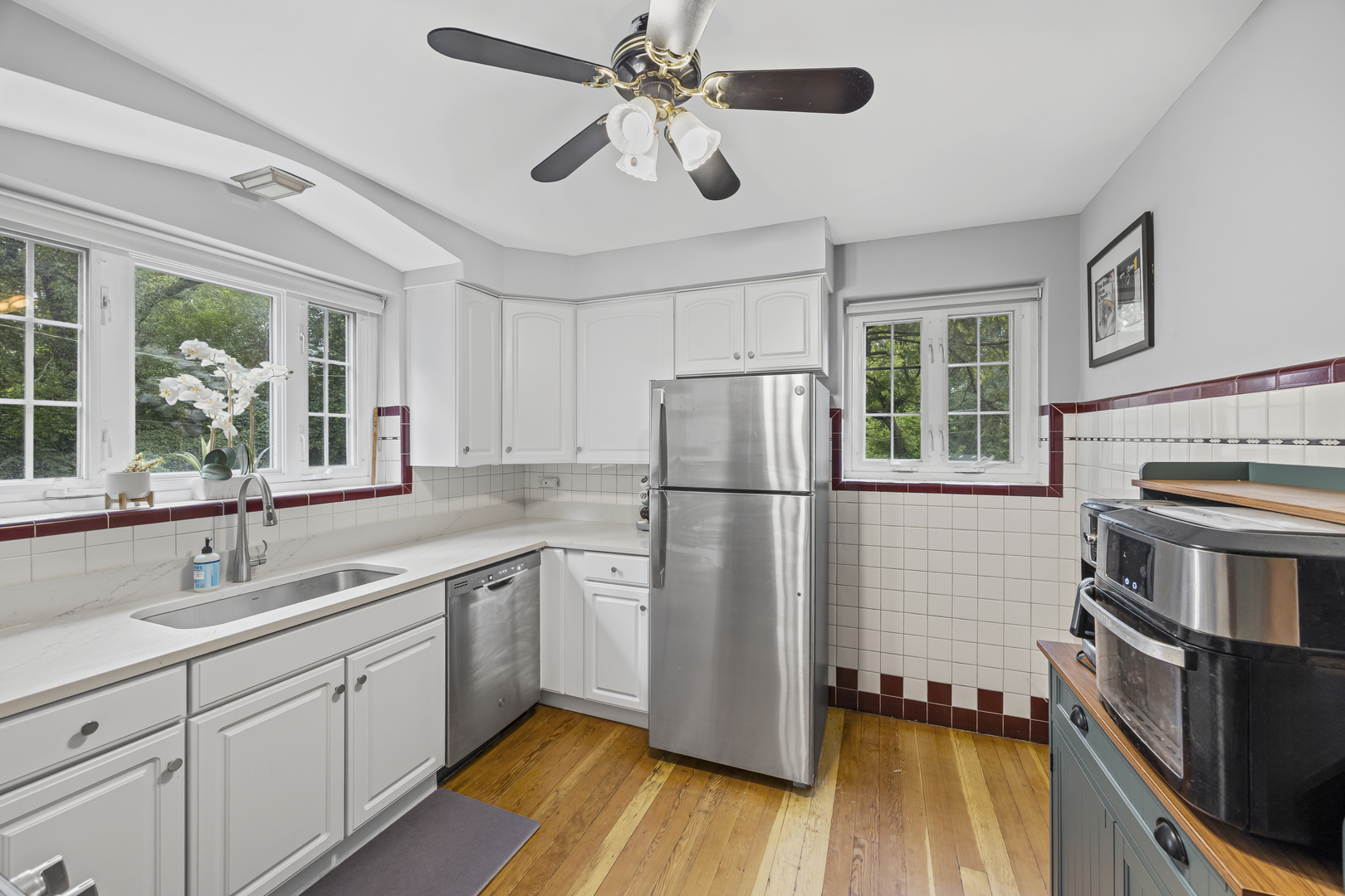 530 Byrd Road Riverside, IL 60546 - Photo 9 of 23 a kitchen with refrigerator cabinets and wooden floor