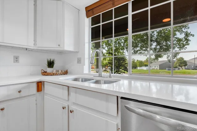 a kitchen with a sink and large window