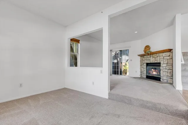 a view of an empty room with a fireplace