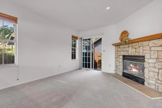 a view of empty room with fireplace and fan