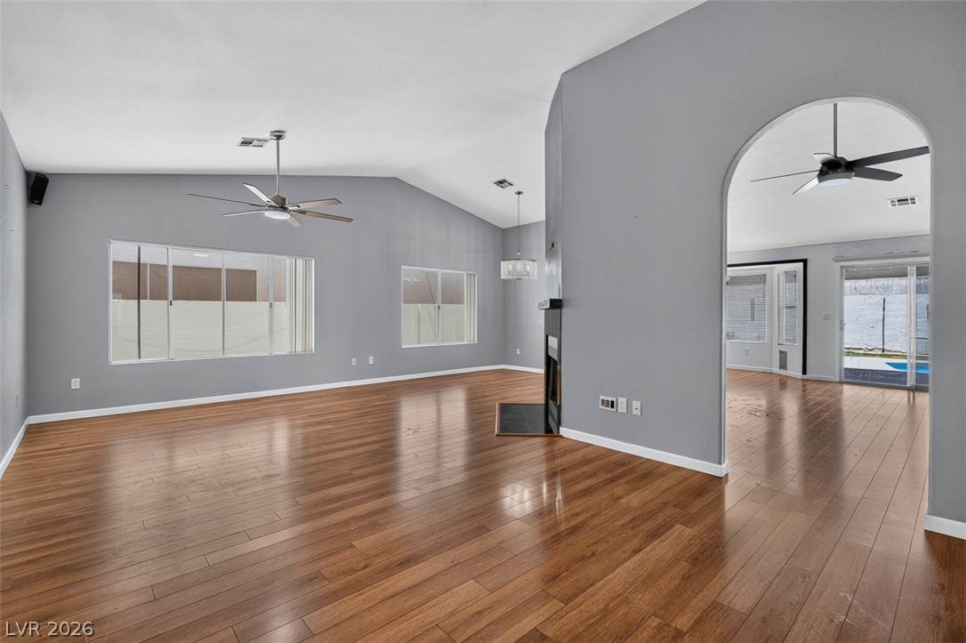 2609 Shakespeare Road Las Vegas, NV 89108 - Photo 6 of 41 Hardwood flooring extends throughout this generous living area, featuring vaulted ceilings and abundant natural light.