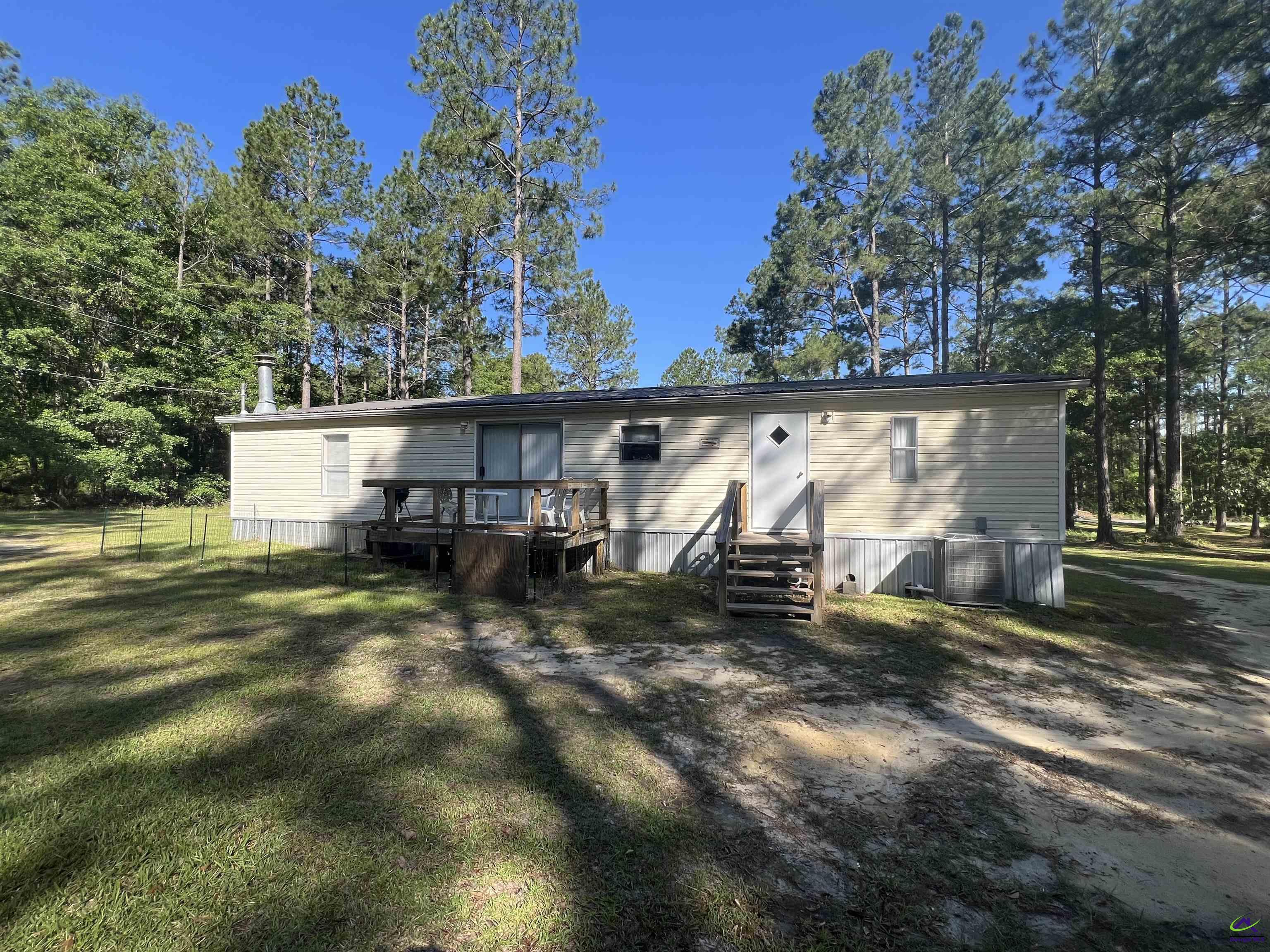 166 Pebble Hills Road Cochran, GA 31014 - Photo 4 of 27 a view of a house with a yard