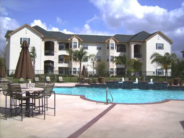 a view of a house with backyard porch and sitting area
