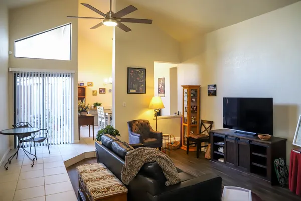 a view of a living room with furniture and a book shelf