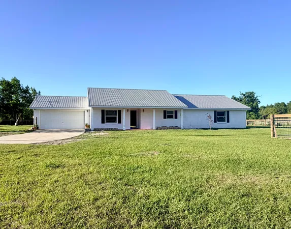 a front view of house with yard and seating area