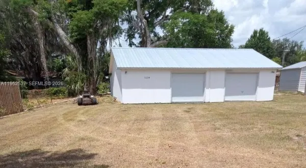 a house that has a tree in front of it