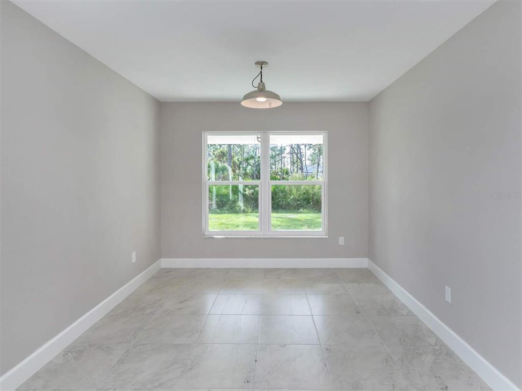 125 Boundary Boulevard, Unit 2 Rotonda West, FL 33947 - Photo 11 of 32 an empty room with a window