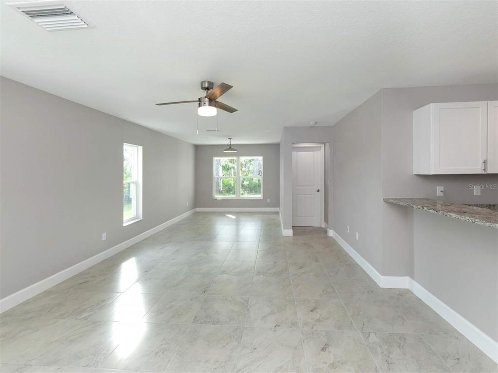 125 Boundary Boulevard, Unit 2 Rotonda West, FL 33947 - Photo 13 of 32 a view of an empty room with a window