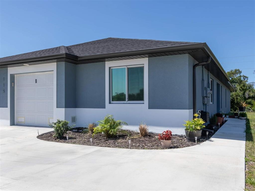 125 Boundary Boulevard, Unit 2 Rotonda West, FL 33947 - Photo 2 of 32 a front view of a house