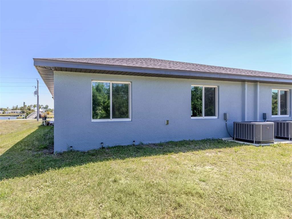 125 Boundary Boulevard, Unit 2 Rotonda West, FL 33947 - Photo 27 of 32 a view of a house with backyard and porch