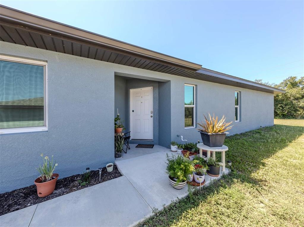 125 Boundary Boulevard, Unit 2 Rotonda West, FL 33947 - Photo 29 of 32 a front view of a house with patio outdoor seating