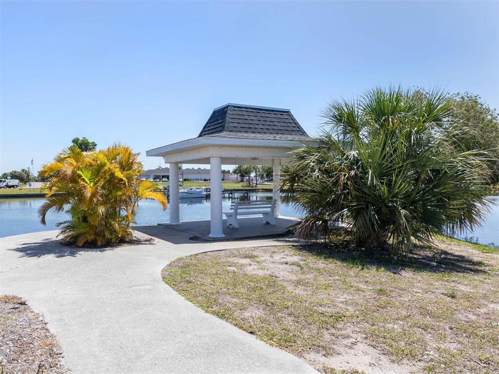 125 Boundary Boulevard, Unit 2 Rotonda West, FL 33947 - Photo 31 of 32 a view of a house with a yard
