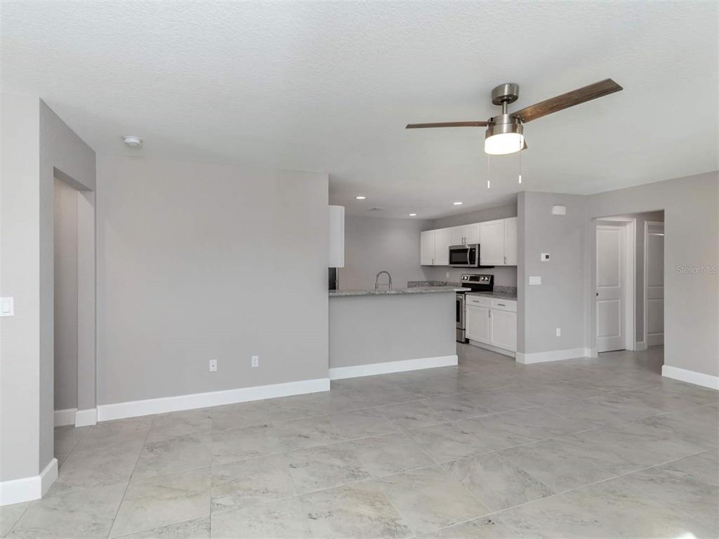 125 Boundary Boulevard, Unit 2 Rotonda West, FL 33947 - Photo 9 of 32 a view of a kitchen with kitchen island and stainless steel appliances