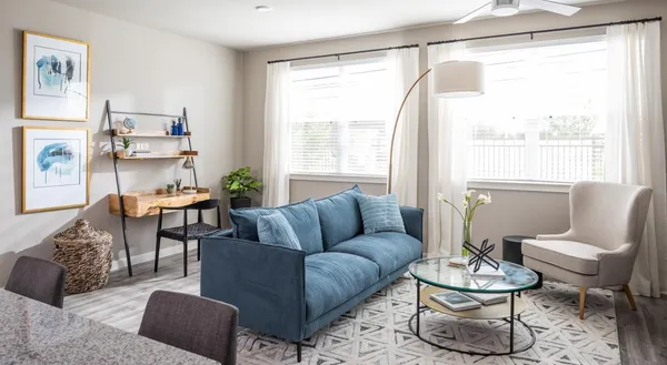 a living room with furniture and a large window