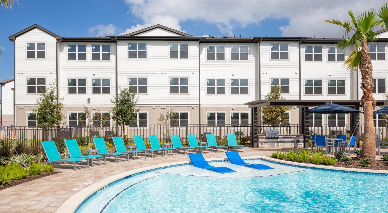 19770 Clay Road, Unit 66308 Katy, TX 77449 - Photo 21 of 35 a front view of a house with swimming pool and glass door