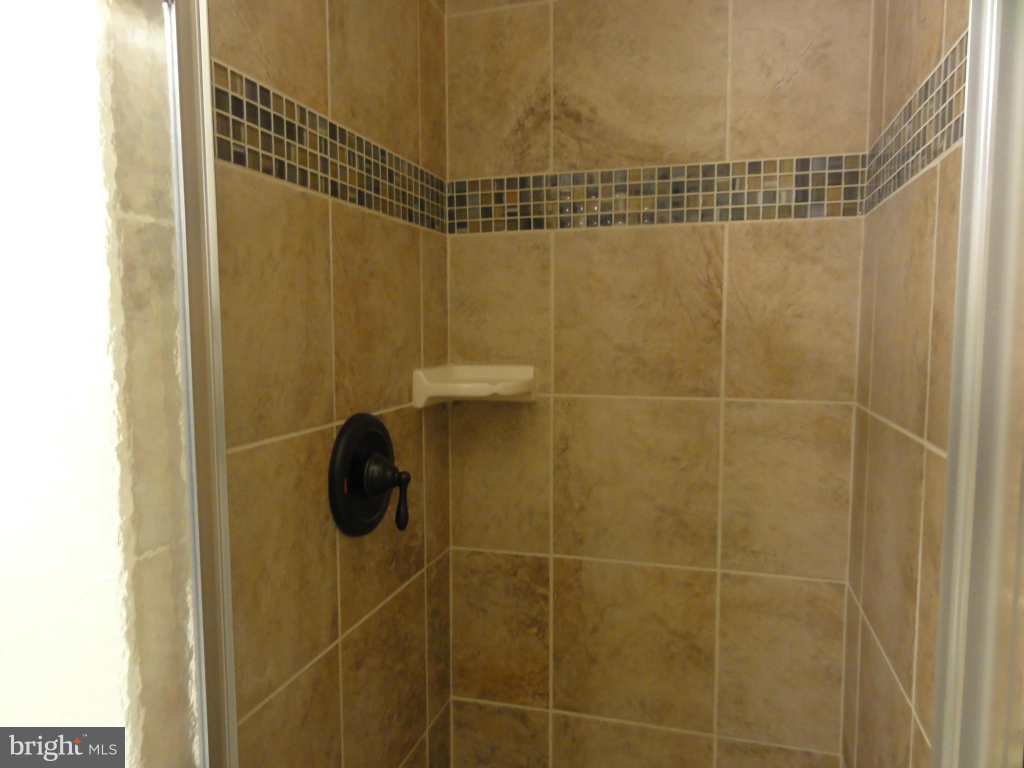 1105 Newfield Road Baltimore, MD 21207 - Photo 23 of 27 Lower level bath with decorative tile