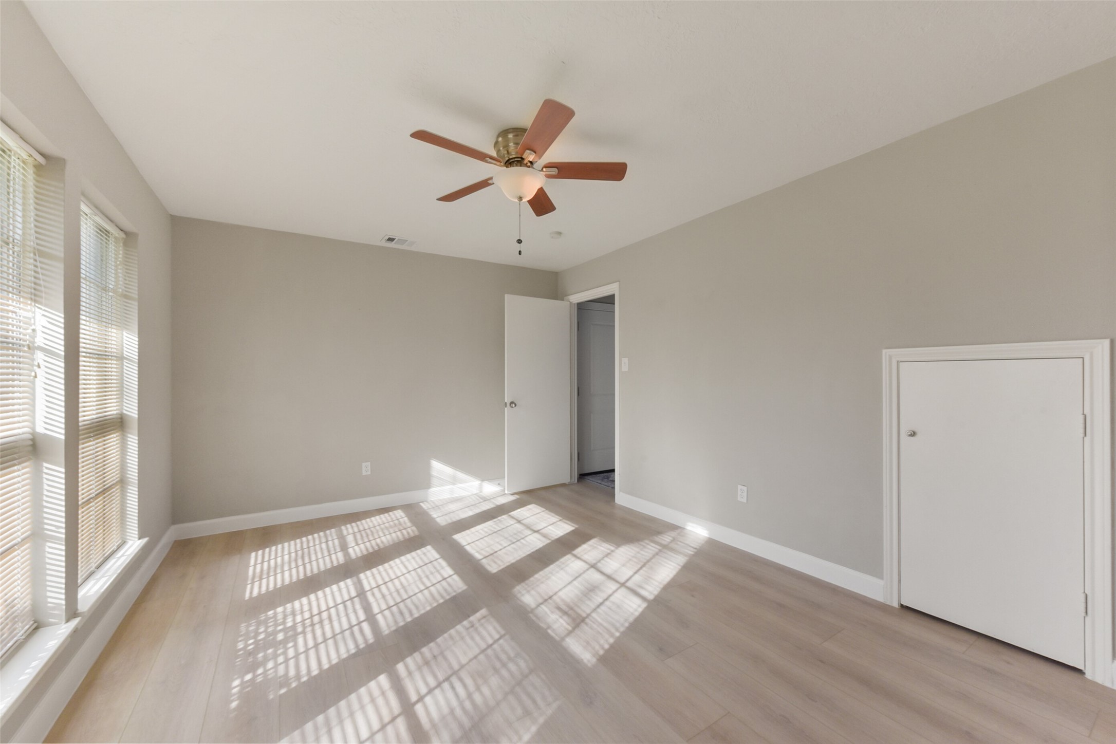 1941 Country Village Boulevard, Unit A Humble, TX 77338 - Photo 21 of 35 a view of a big room with wooden floor and windows in a room