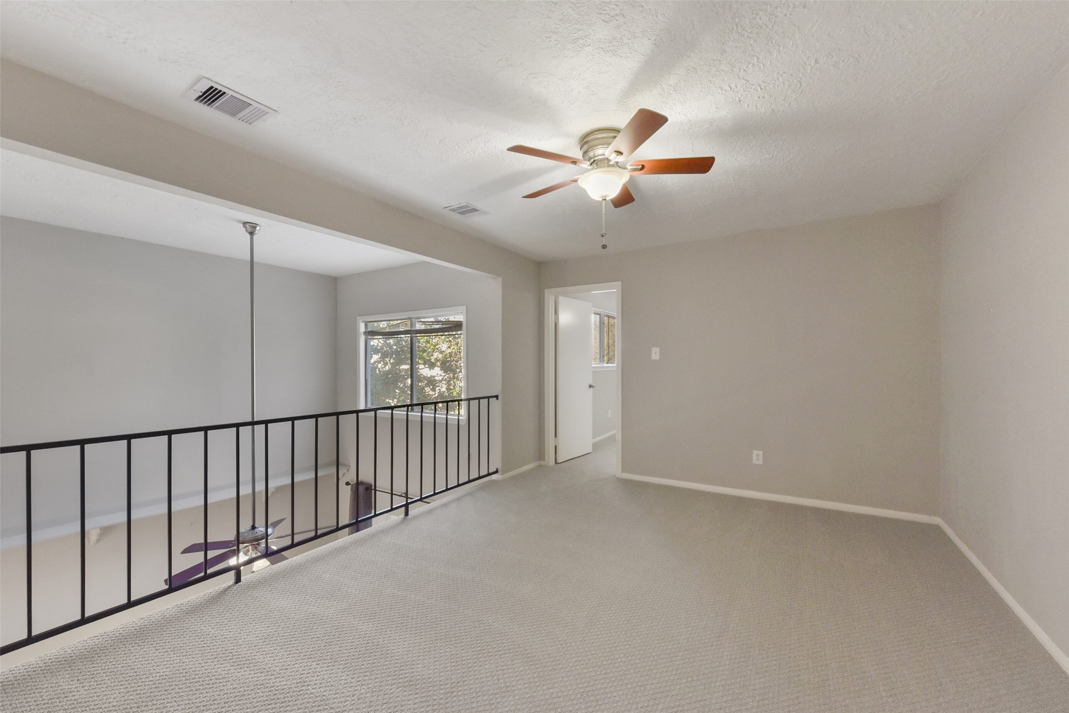 1941 Country Village Boulevard, Unit A Humble, TX 77338 - Photo 26 of 35 a view of a hallway with a ceiling fan