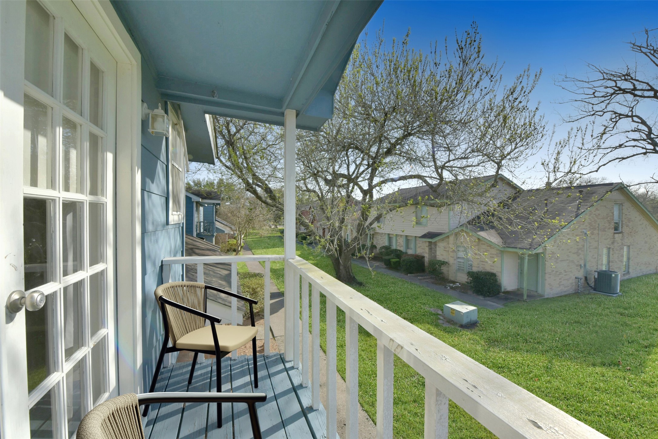 1941 Country Village Boulevard, Unit A Humble, TX 77338 - Photo 30 of 35 a view of a balcony with two chairs and a table