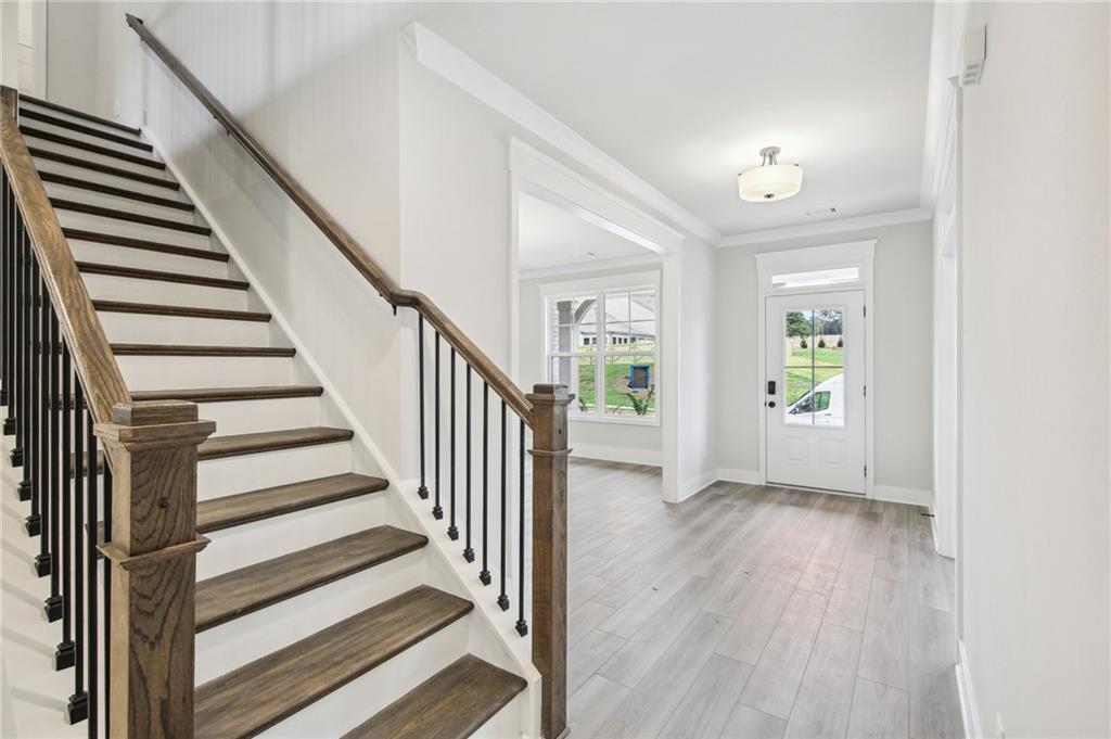 369 Scarlet Rose Way Hoschton, GA 30548 - Photo 18 of 150 a view of a hallway with wooden floor and entryway