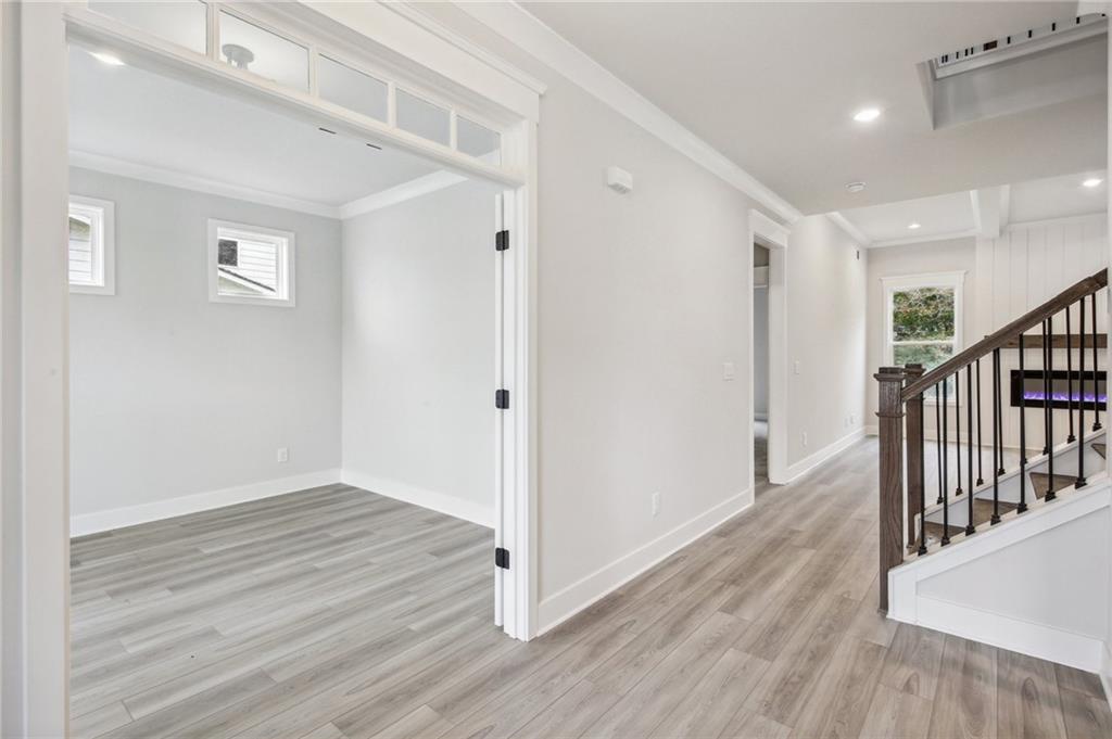 369 Scarlet Rose Way Hoschton, GA 30548 - Photo 19 of 150 a view of a hallway with wooden floor